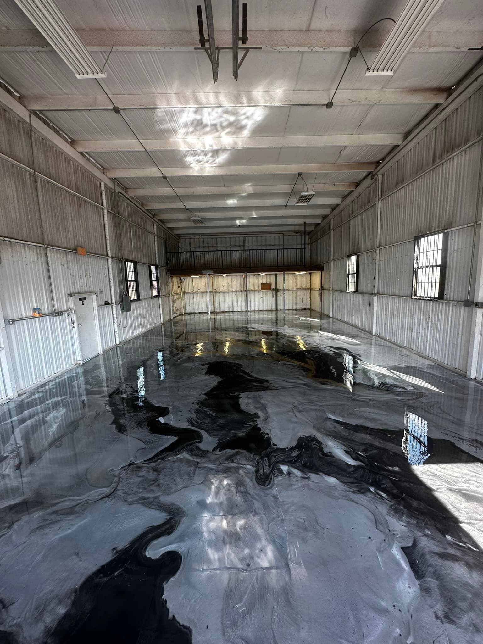 Grey flake epoxy patio floor beside a glass door and pool.